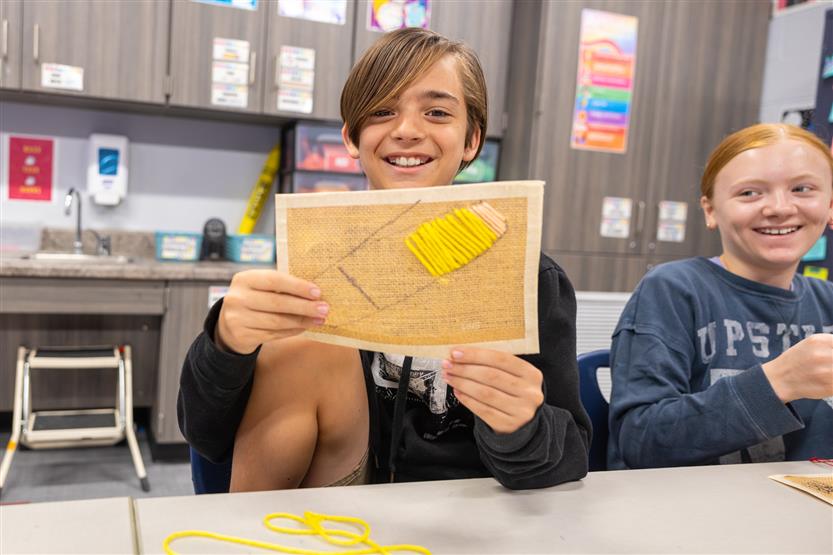 Students learning about embroidery